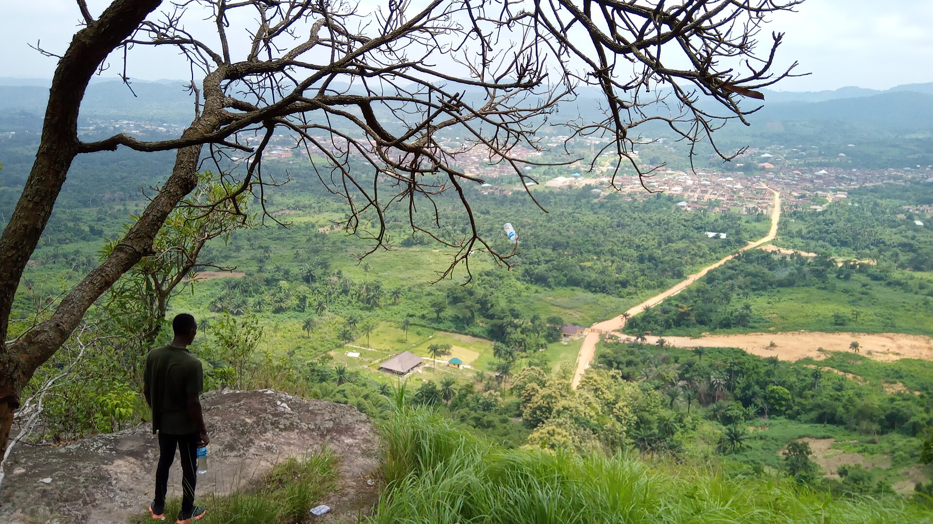 Green landscape and settlement seen from high ground around Erin-Ijesa